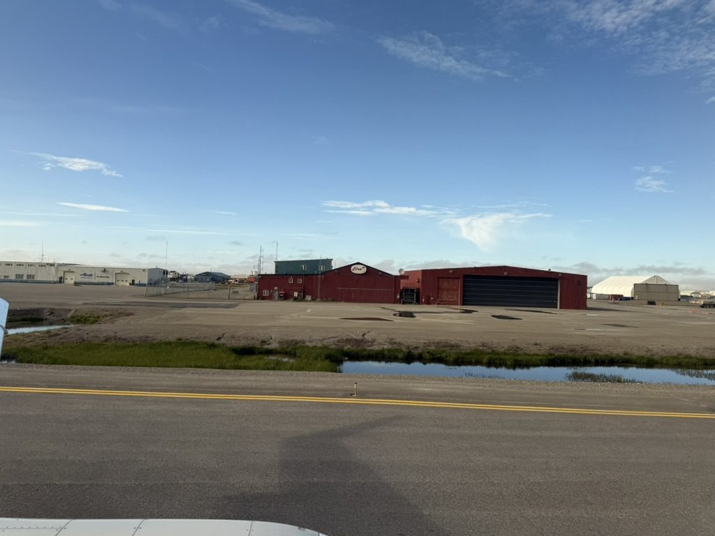 The two Deadhorse hangars seen from the airfield road under clear sky