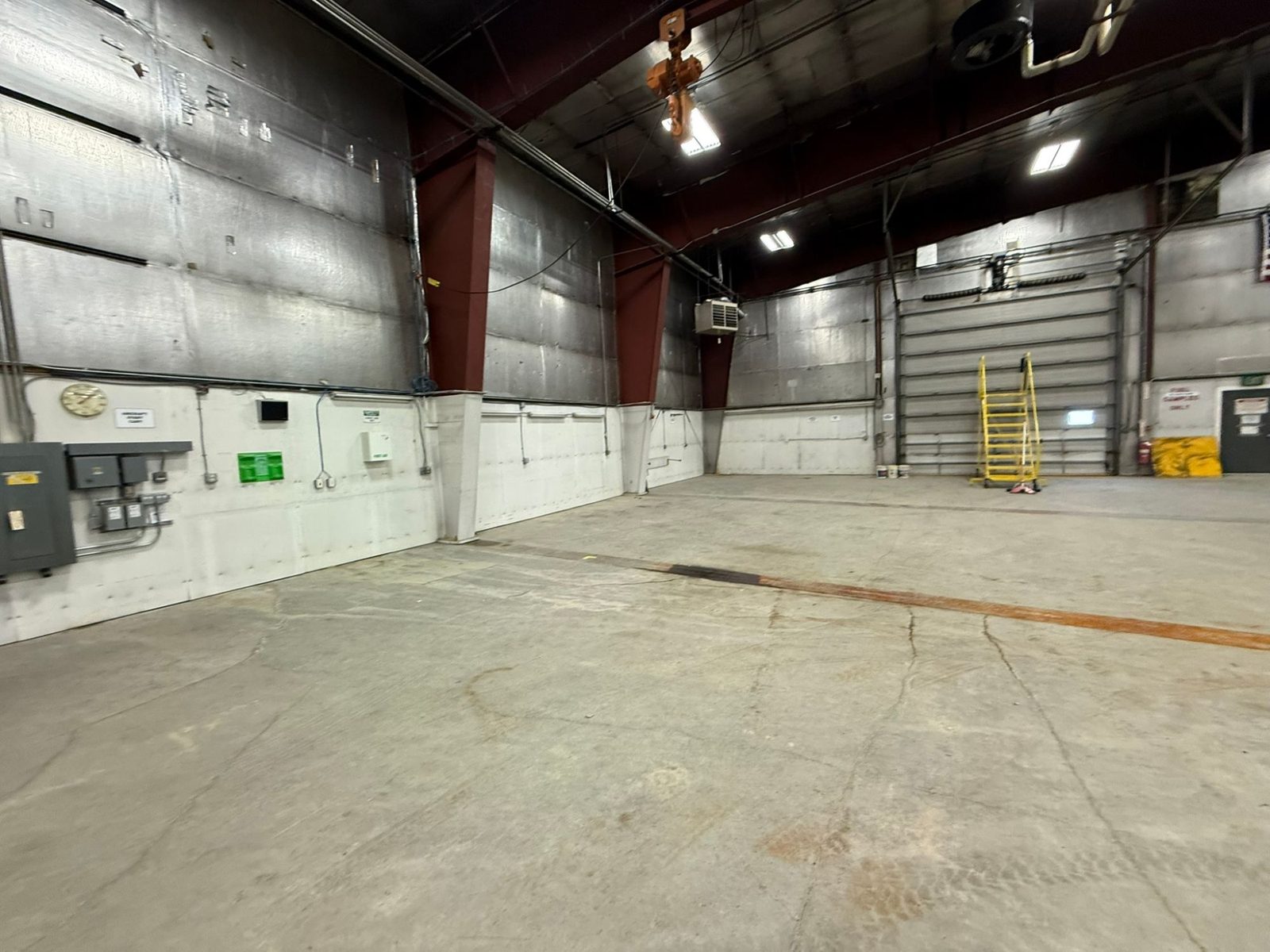 Main hangar interior showing the clear-span floor and overhead hoist