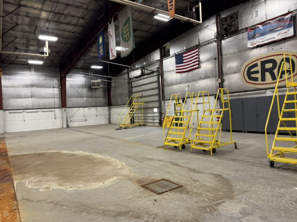 Hangar interior with work stands and mezzanine offices beyond