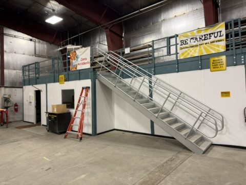 Steel stair to the mezzanine level above the shop offices